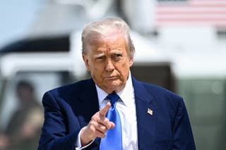Donald Trump gestures as he walks to board Air Force One at Joint Base Andrews in Maryland